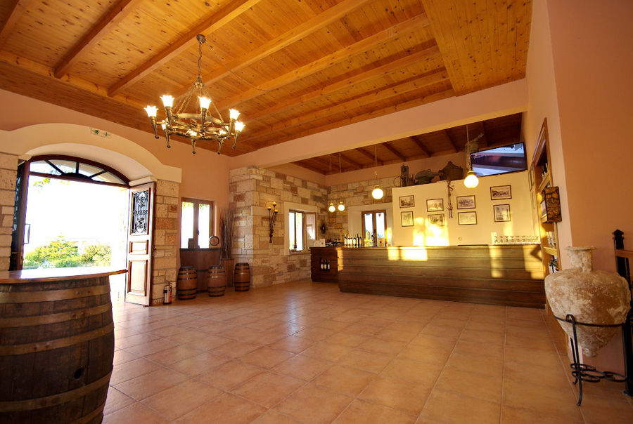 Hatziemmanouil Winery tasting room with wood ceiling and entrance with stone arcade