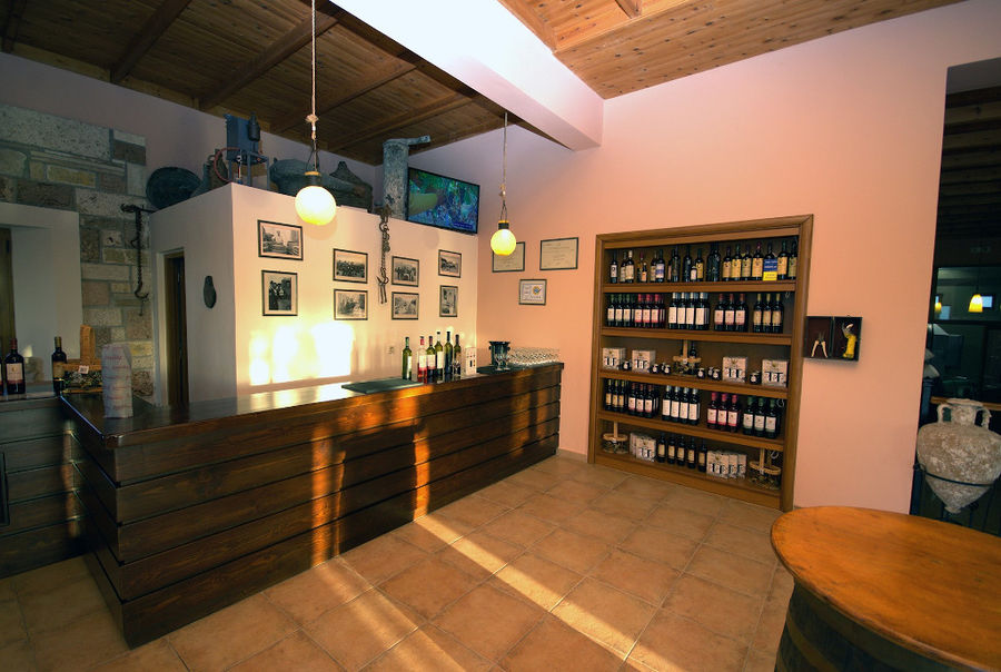 Hatziemmanouil Winery tasting room with wine bottles in the storage locker