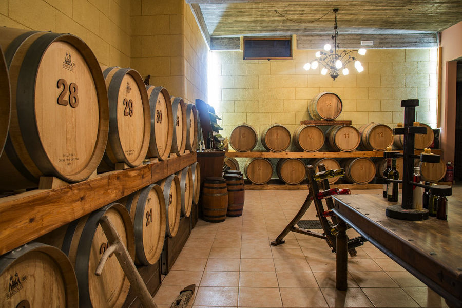 personalized wooden wine barrels sign with the Hatziemmanouil Winery logo and numbers into the cellar