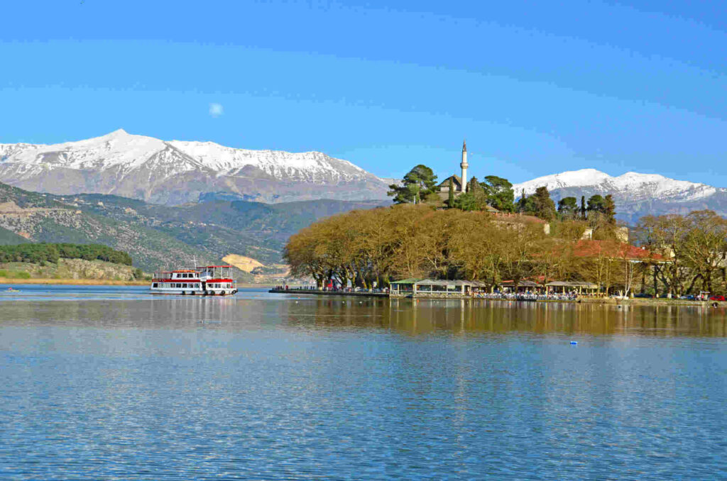 a boat on a lake with mountains in the background