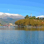 a boat on a lake with mountains in the background