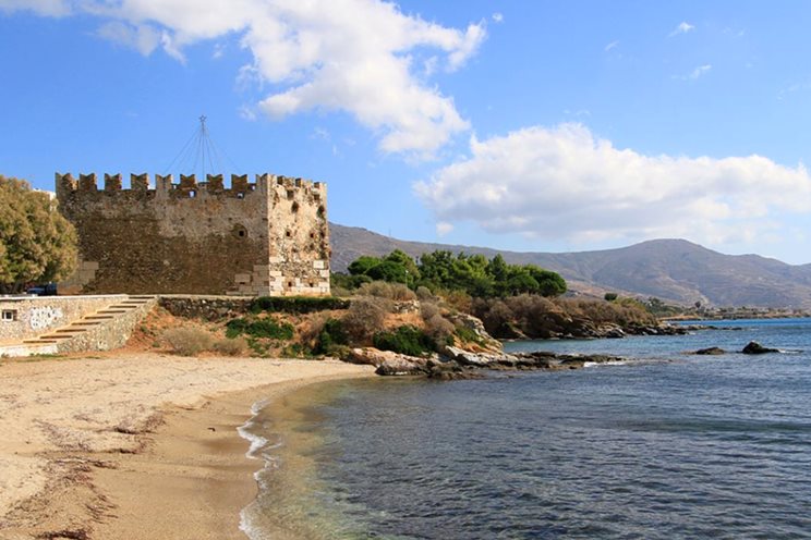 a stone building on a beach