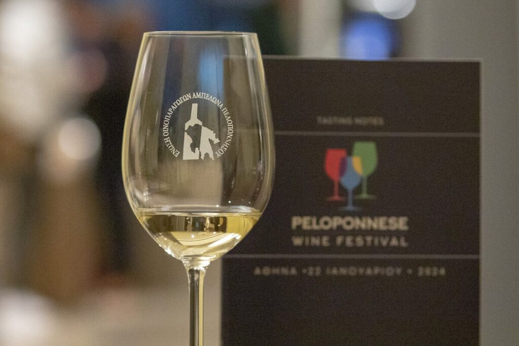 a glass of wine with a logo on it