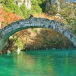 a stone bridge over a river