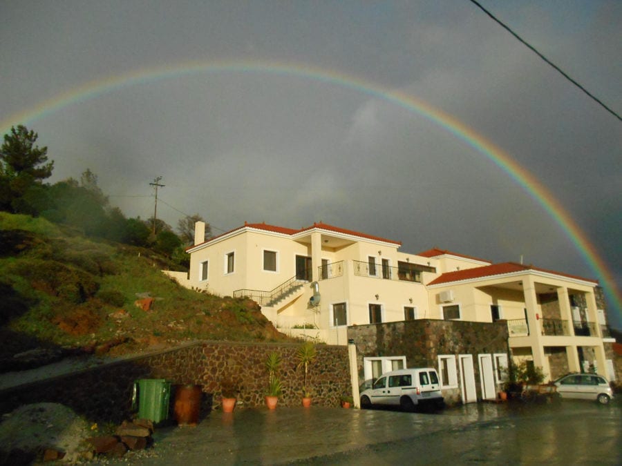 'Agrotouristic Women's Cooperative of Mesotopos Lesvos' building with rainbow with all the colors in the background