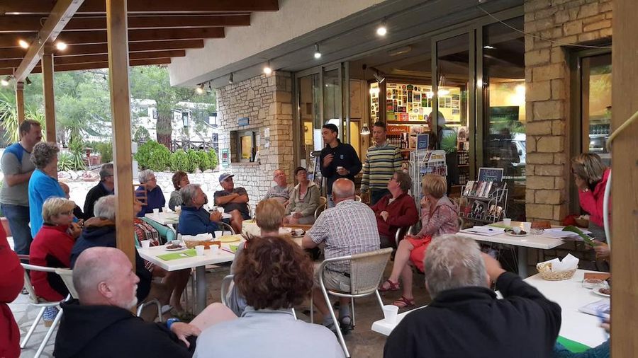 visitors sitting and listening to a guide outside of the terrace -Gastronomy Tours.jpg