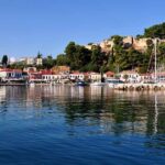 a body of water with buildings and trees