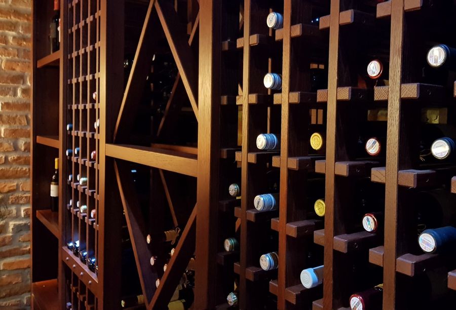 wine-bottles-in-wooden-rack-in-winery-2022-11-14-17-52-35-utc.jpg