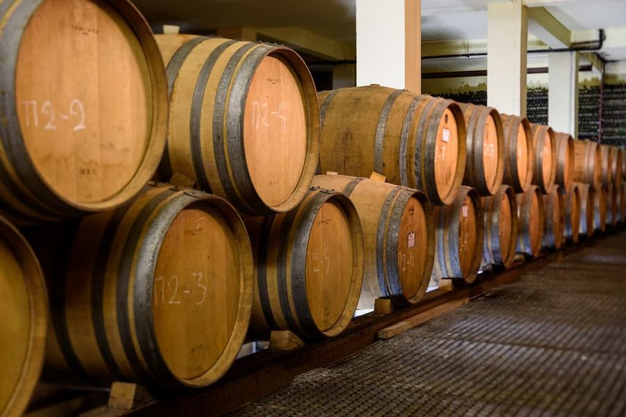 wine wood barrels on top of each other on the one side at 'Boutari Santorini winery'
